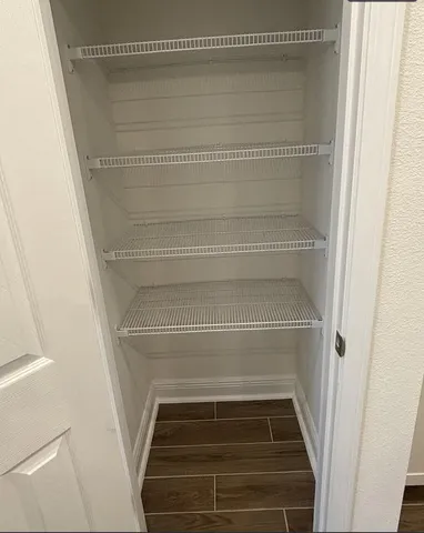 a living room with furniture a rug and white walls