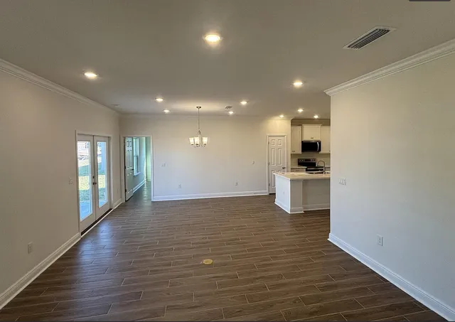 a view of room with window and wooden floor