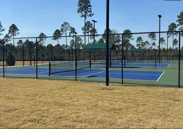 a living room with furniture kitchen view and a flat screen tv