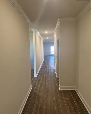 a view of hallway with wooden floor