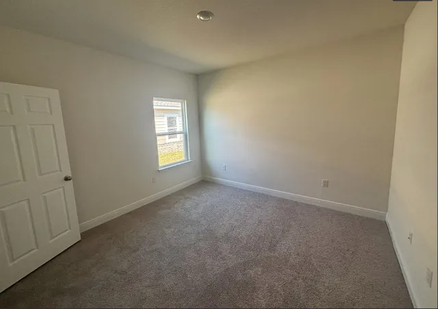 a kitchen with a sink and wooden floor