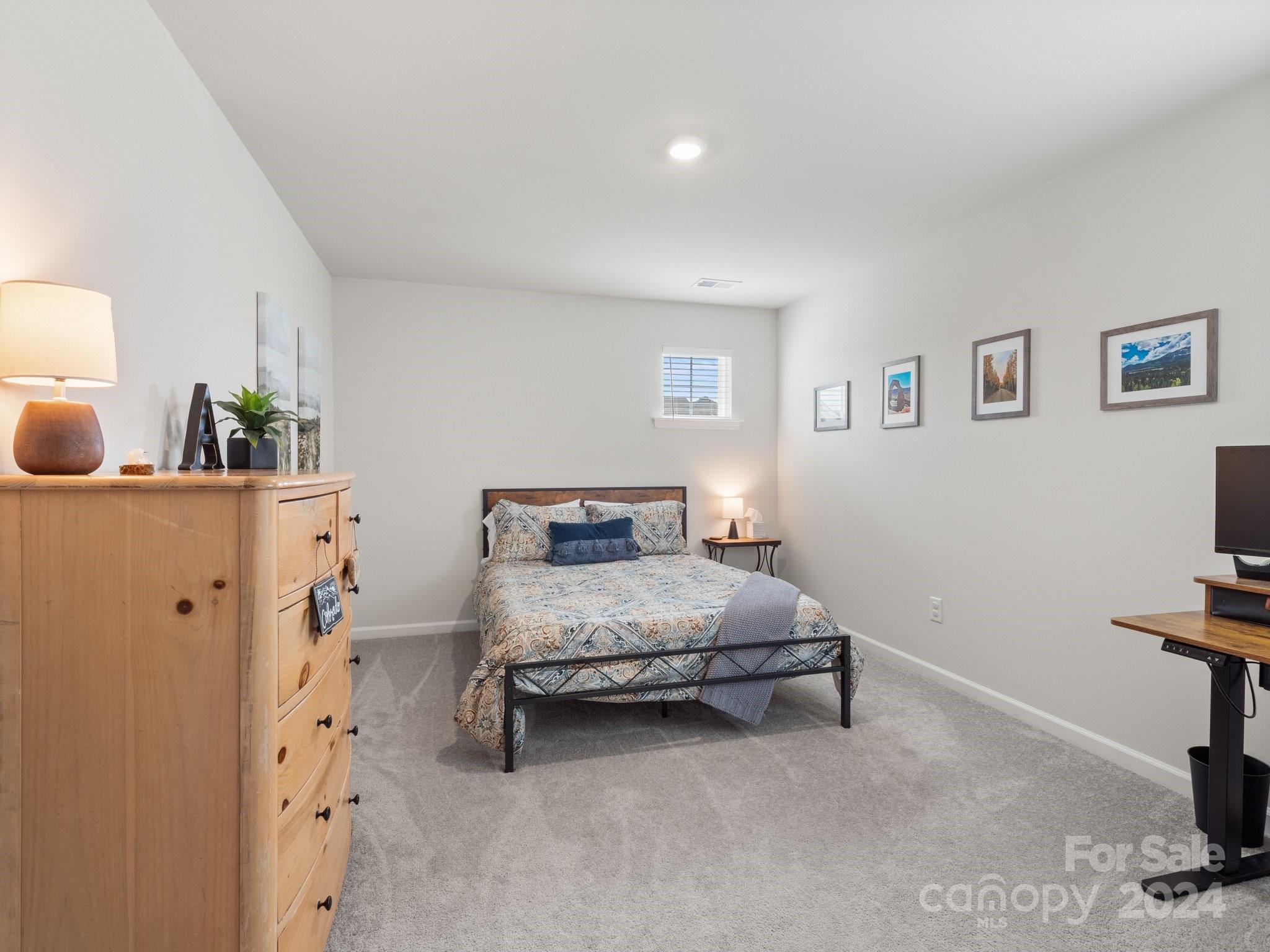 6515 Gopher Road Lancaster, SC 29720 - Photo 22 of 35 a bedroom with a bed and a lamp on dresser