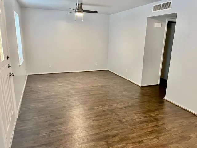 a view of a room with wooden floor and staircase