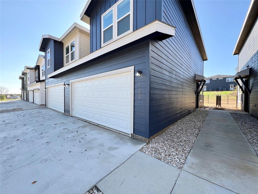 3501 East Renfro Street, Unit 122 Burleson, TX 76028 - Photo 2 of 29 a front view of a house with garage