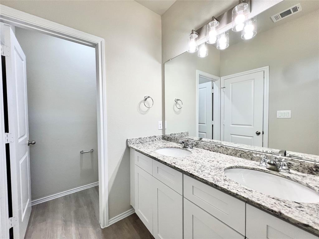 3501 East Renfro Street, Unit 122 Burleson, TX 76028 - Photo 27 of 29 a bathroom with a double vanity sink and a mirror