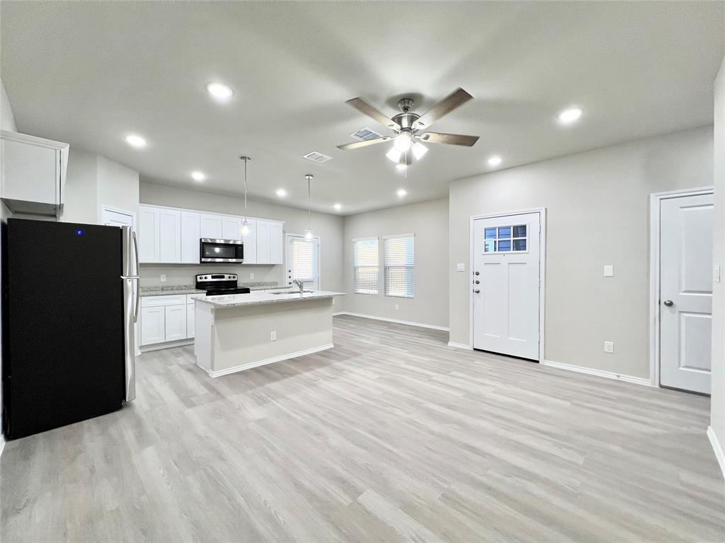 3501 East Renfro Street, Unit 122 Burleson, TX 76028 - Photo 29 of 29 a view of kitchen with refrigerator and white cabinets