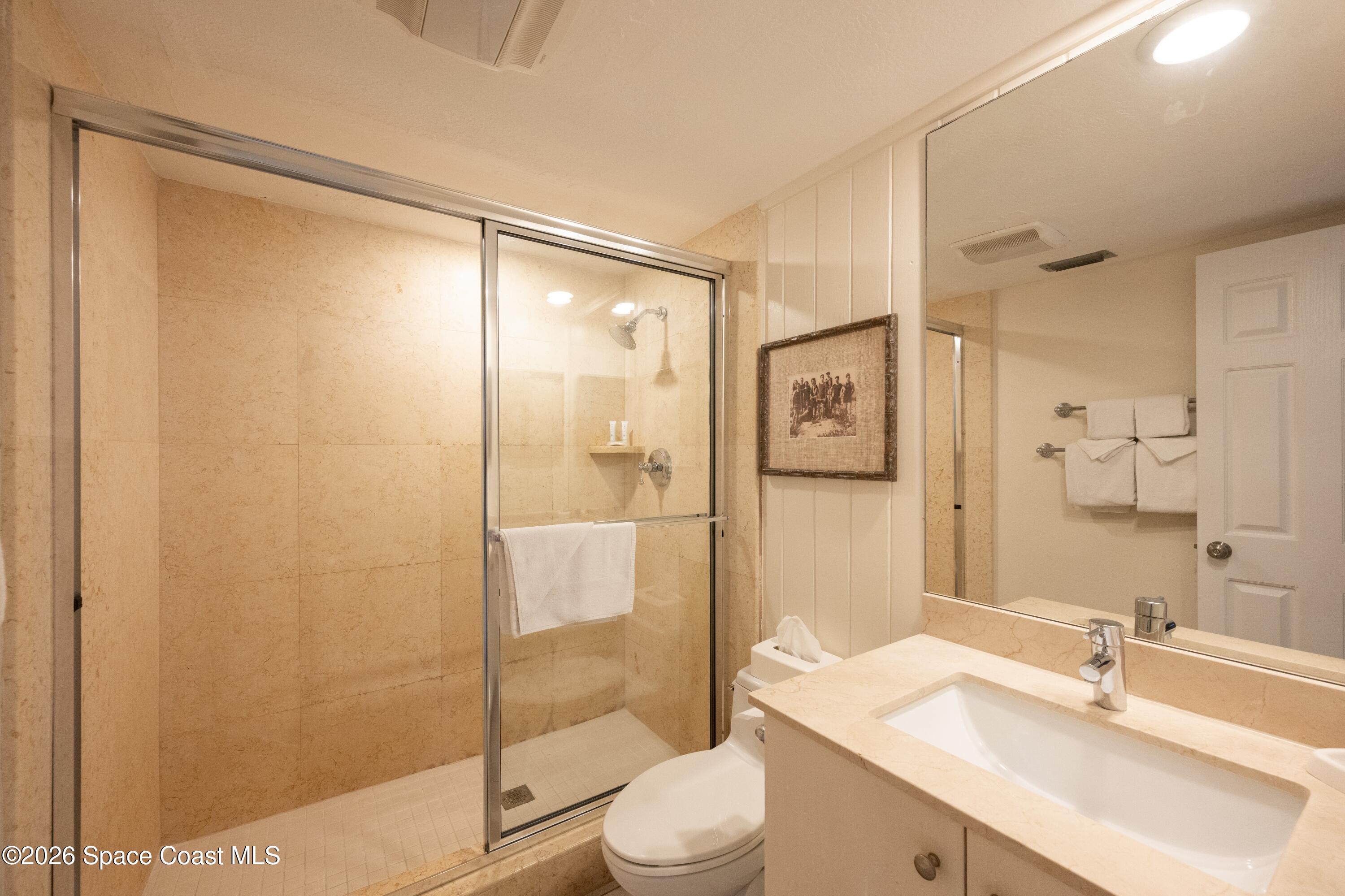 617 Front Street, Unit A52 Key West, FL 33040 - Photo 27 of 42 a bathroom with a sink mirror toilet and shower