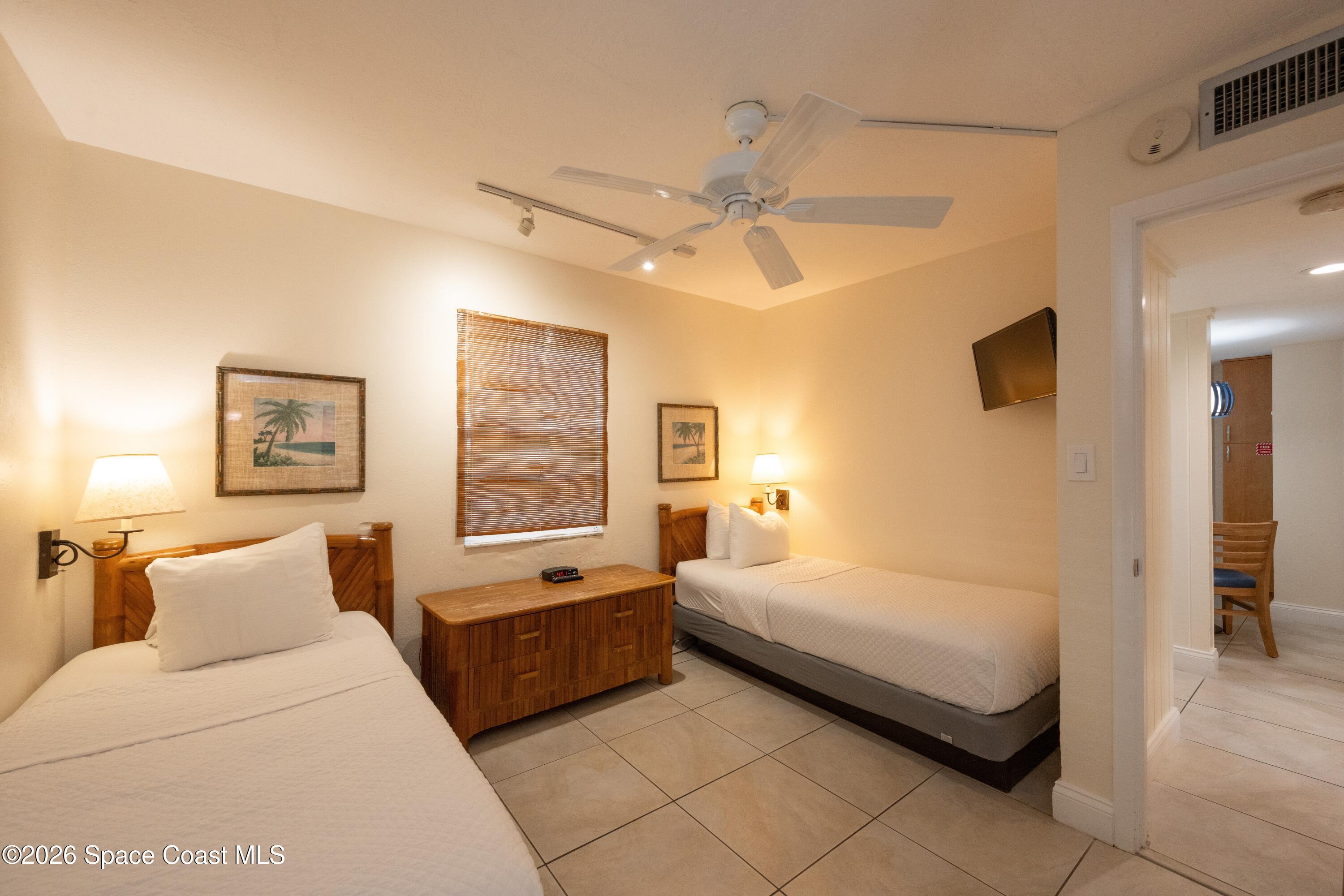 617 Front Street, Unit A52 Key West, FL 33040 - Photo 28 of 42 a spacious bedroom with a bed and ceiling fan