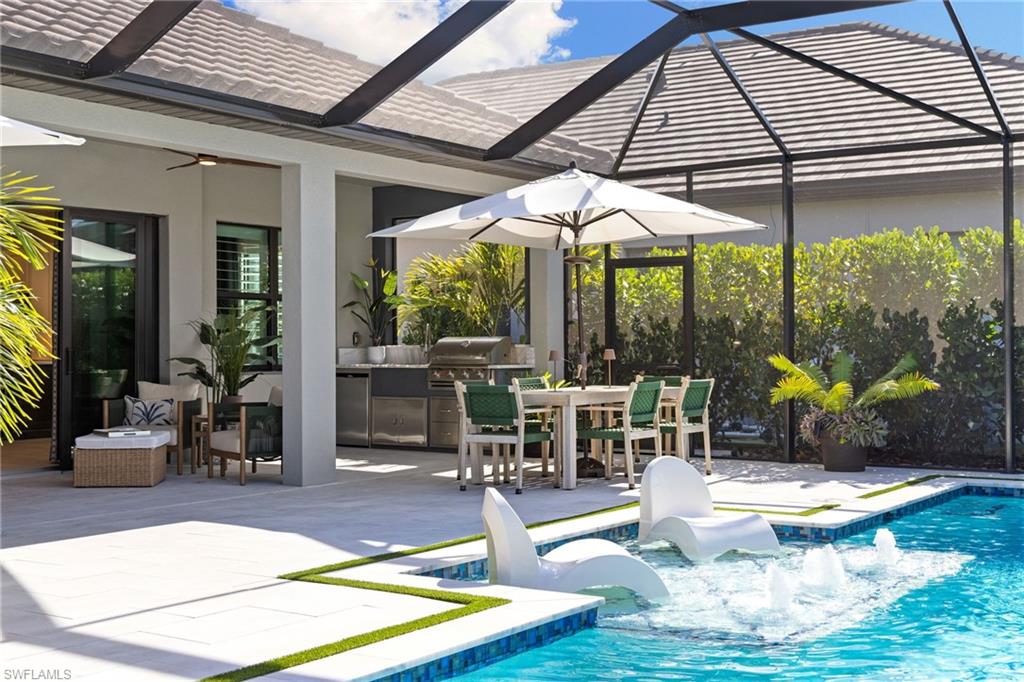 3967 Pegasus Way Naples, FL 34120 - Photo 25 of 50 a view of a patio with table and chairs under an umbrella
