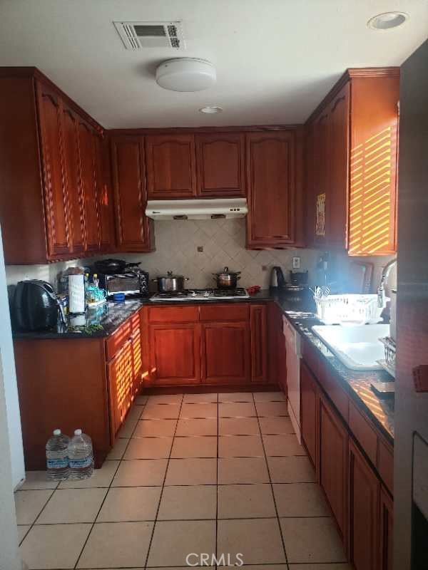 12047 Deana Street El Monte, CA 91732 - Photo 7 of 7 a kitchen with stainless steel appliances granite countertop a stove a sink dishwasher and cabinets