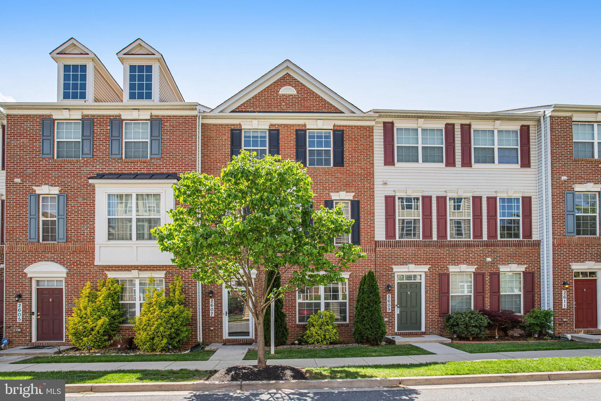 a front view of a residential apartment building with a yard