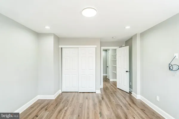 a view of hallway with wooden floor