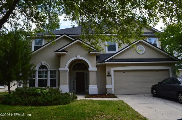 a front view of a house with a yard and garage