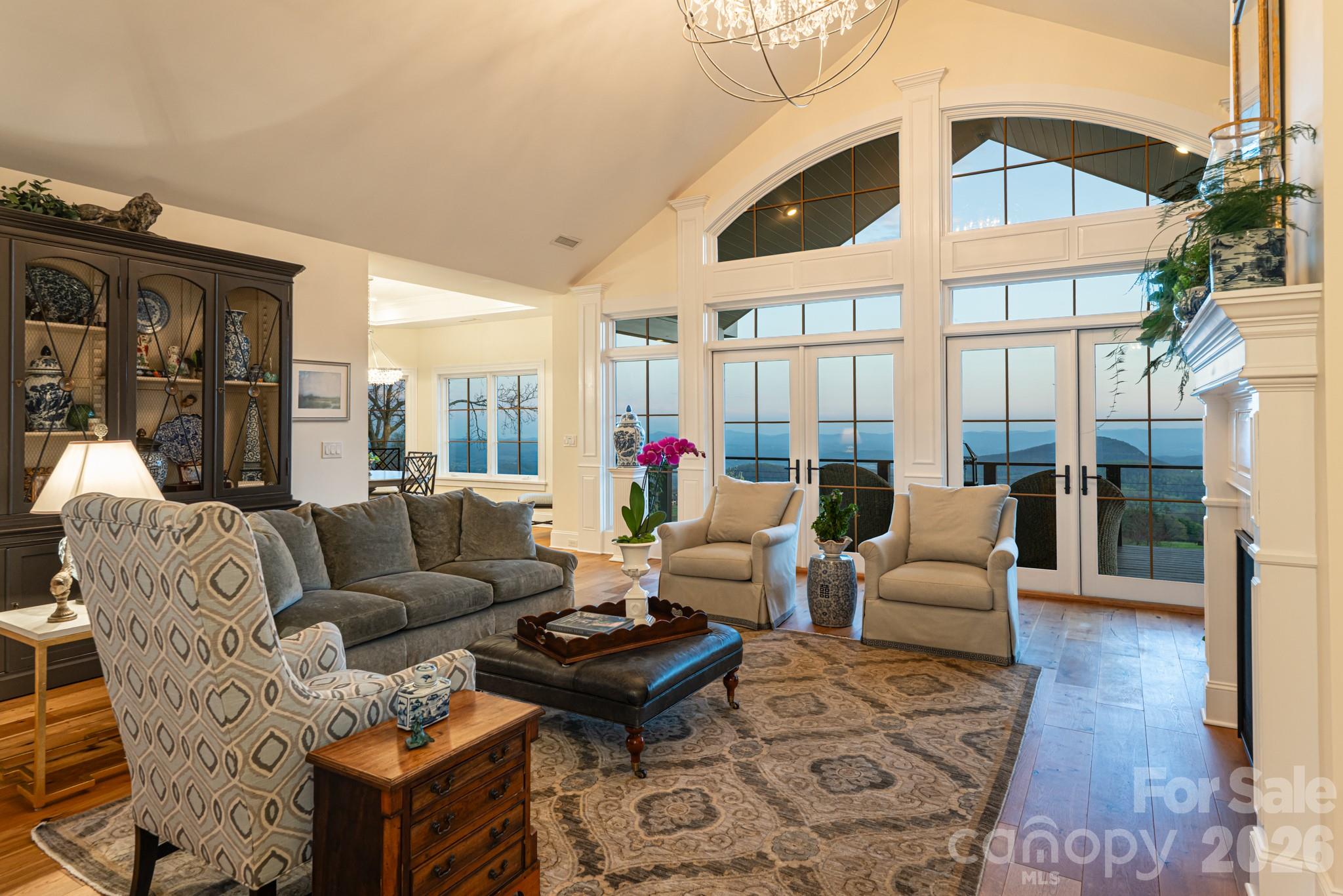 89 North Snow Ridge Drive, Unit 13 Hendersonville, NC 28792 - Photo 12 of 47 a living room with furniture a table and a large window