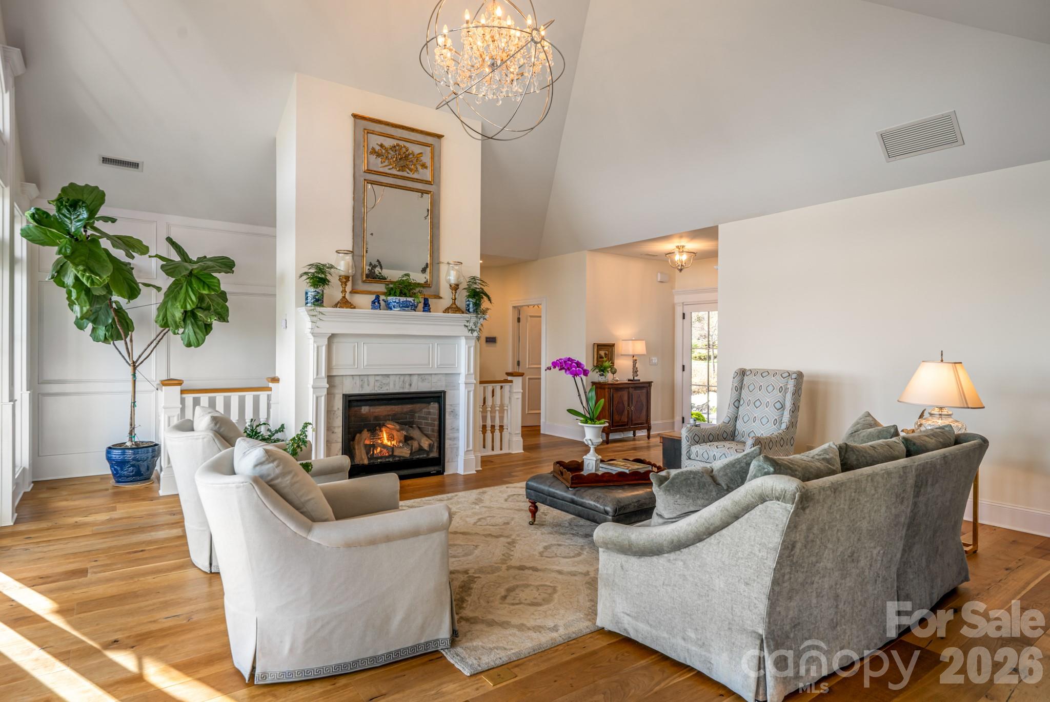 89 North Snow Ridge Drive, Unit 13 Hendersonville, NC 28792 - Photo 13 of 47 a living room with furniture a fireplace and a chandelier