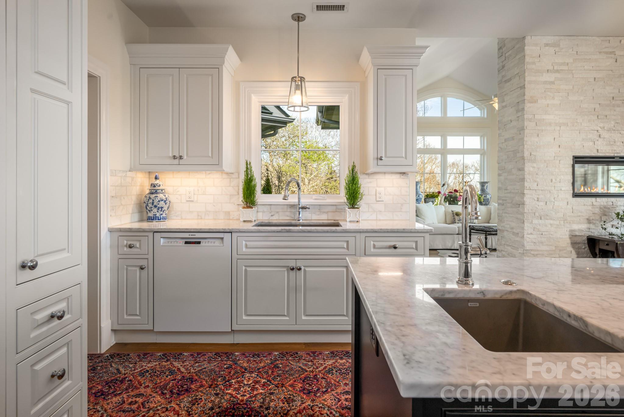 89 North Snow Ridge Drive, Unit 13 Hendersonville, NC 28792 - Photo 19 of 47 a kitchen with granite countertop a sink and white cabinets