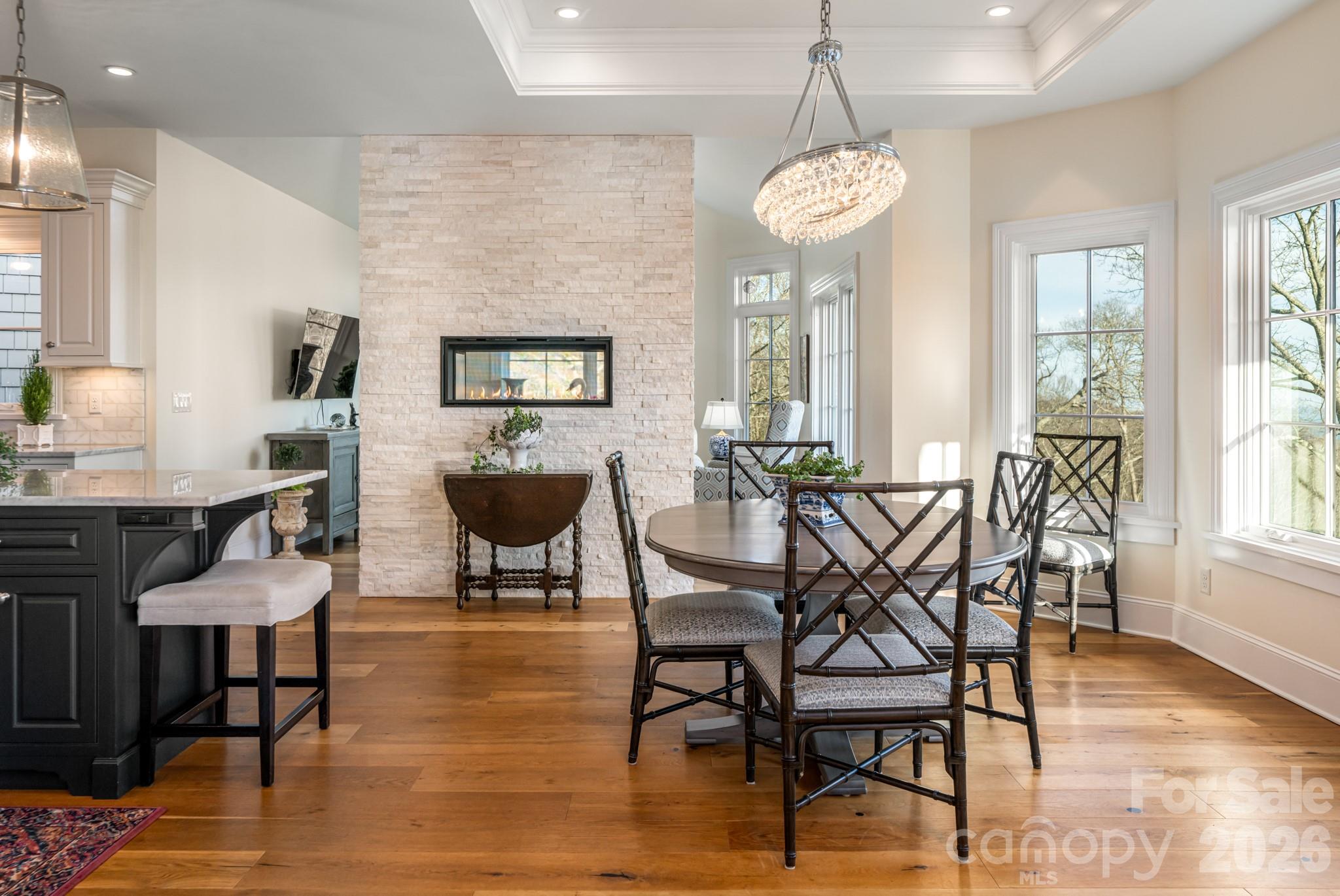 89 North Snow Ridge Drive, Unit 13 Hendersonville, NC 28792 - Photo 20 of 47 a view of a dining room with furniture window and wooden floor