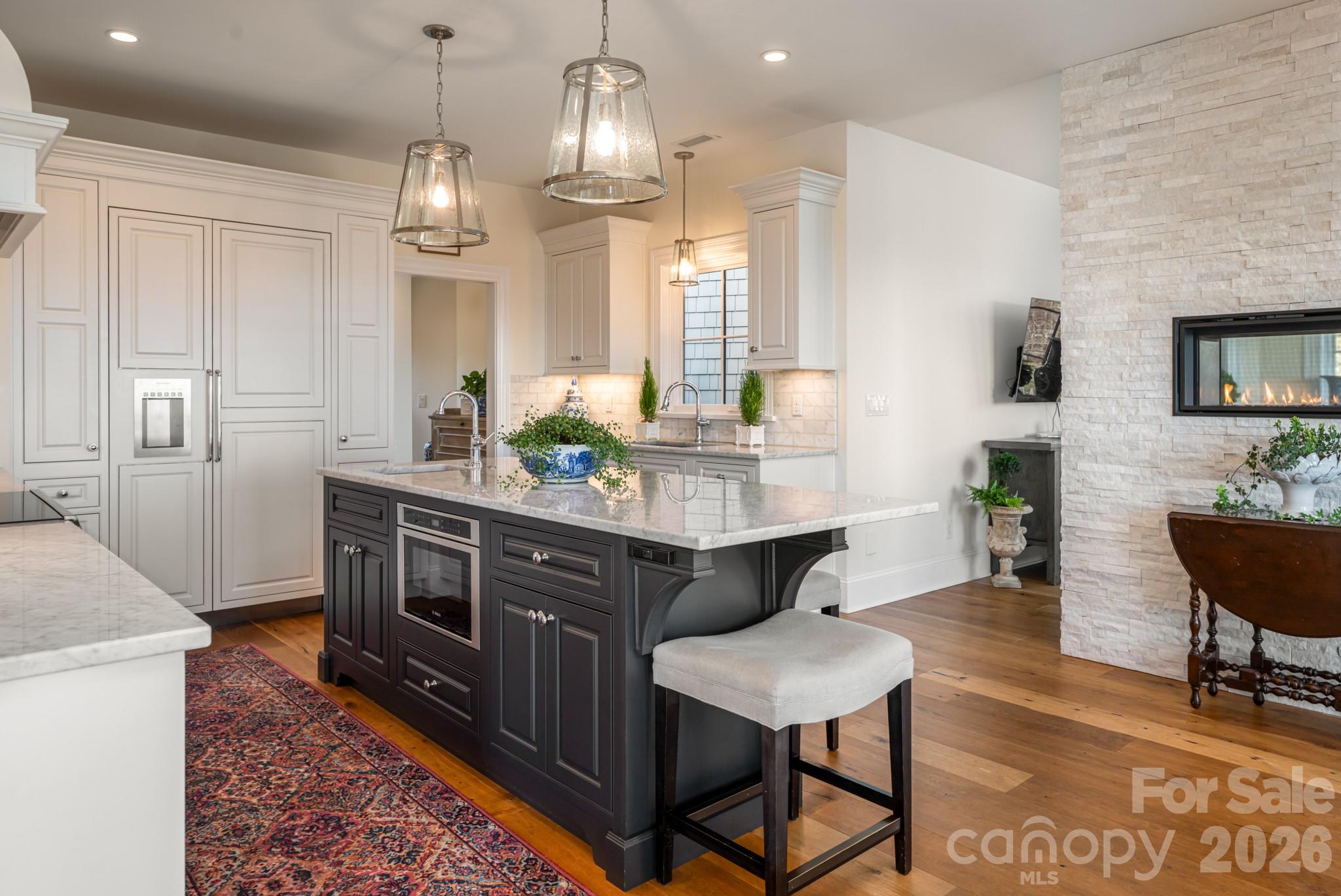 89 North Snow Ridge Drive, Unit 13 Hendersonville, NC 28792 - Photo 22 of 47 a living room with stainless steel appliances kitchen island granite countertop furniture wooden floor and a rug