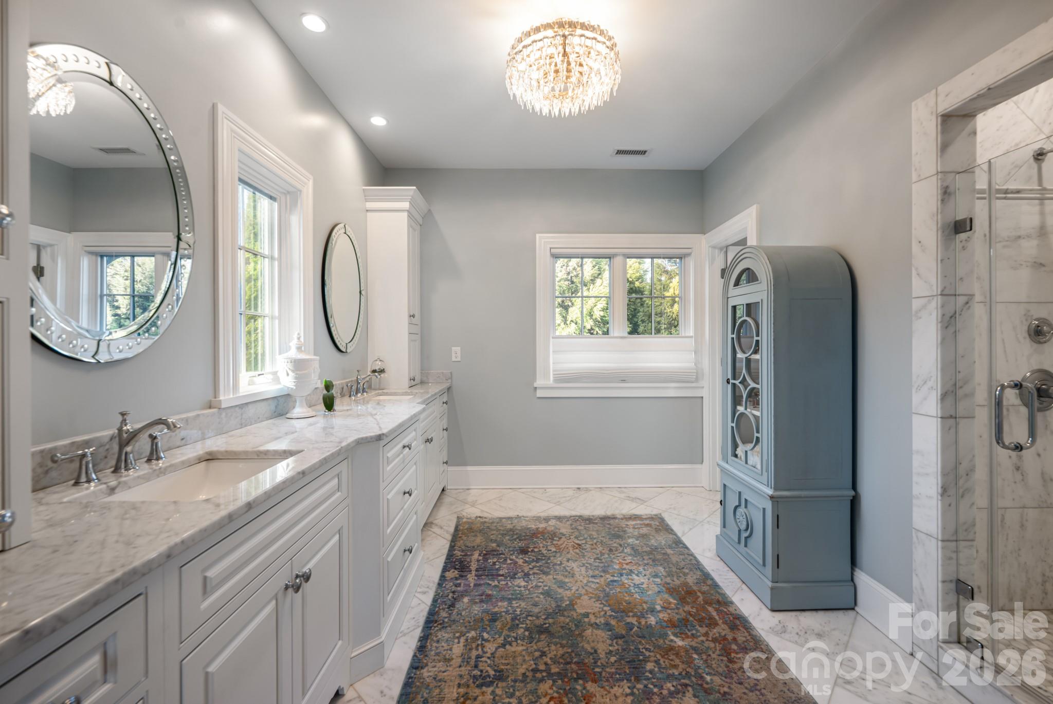 89 North Snow Ridge Drive, Unit 13 Hendersonville, NC 28792 - Photo 33 of 47 a spacious bathroom with a granite countertop sink mirror and a shower