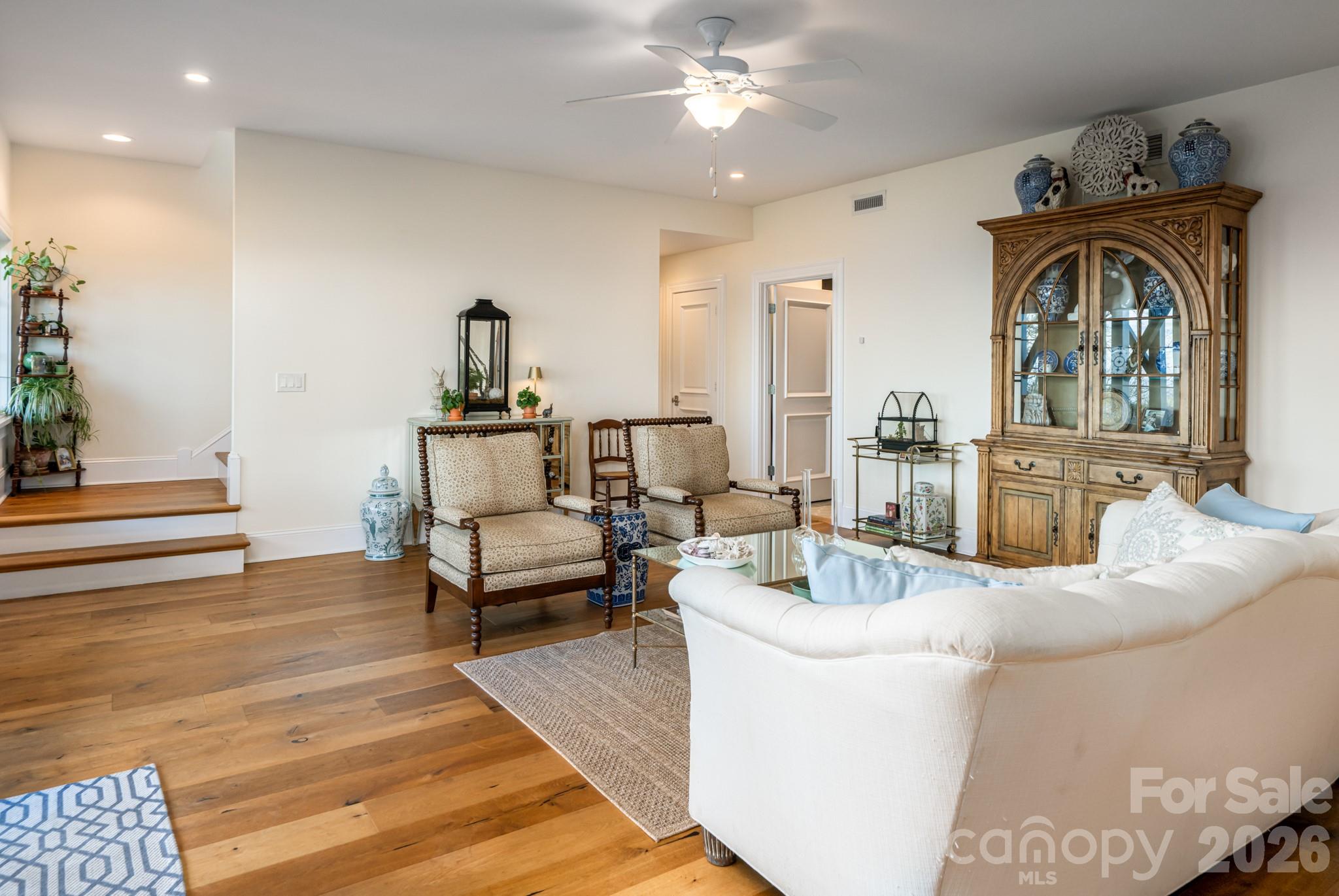 89 North Snow Ridge Drive, Unit 13 Hendersonville, NC 28792 - Photo 38 of 47 a living room with furniture and a chandelier