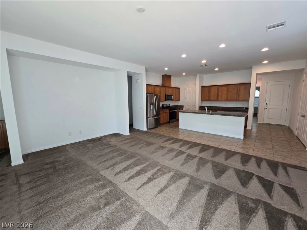 4748 Ritual Street North Las Vegas, NV 89031 - Photo 9 of 31 An open concept living area transitions seamlessly into a well-appointed kitchen.