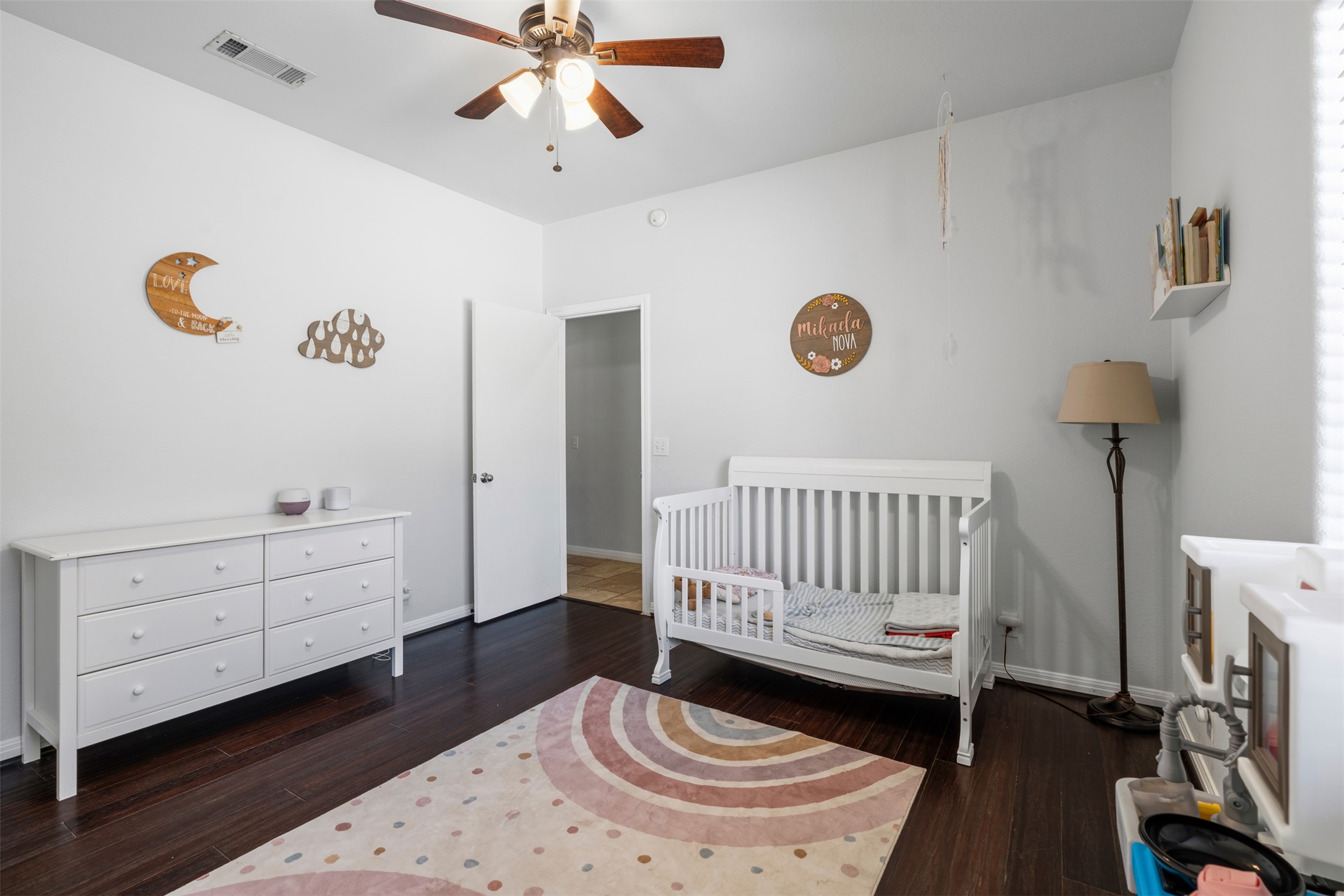 208 Amandas Way Leander, TX 78641 - Photo 14 of 25 Bedroom with dark wood-style flooring, a crib, and ceiling fan