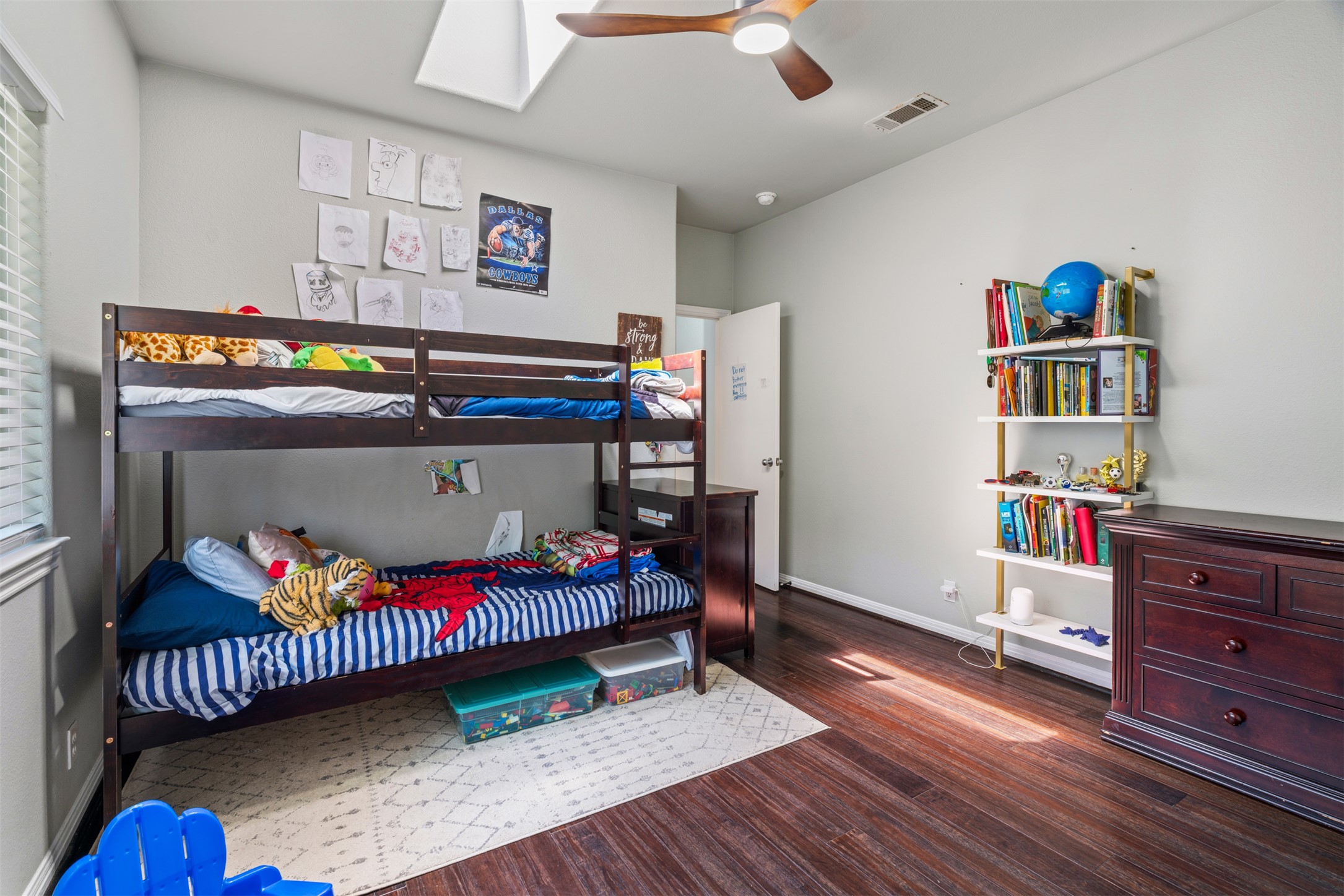 208 Amandas Way Leander, TX 78641 - Photo 17 of 25 Bedroom featuring dark wood-type flooring, a skylight, and a ceiling fan