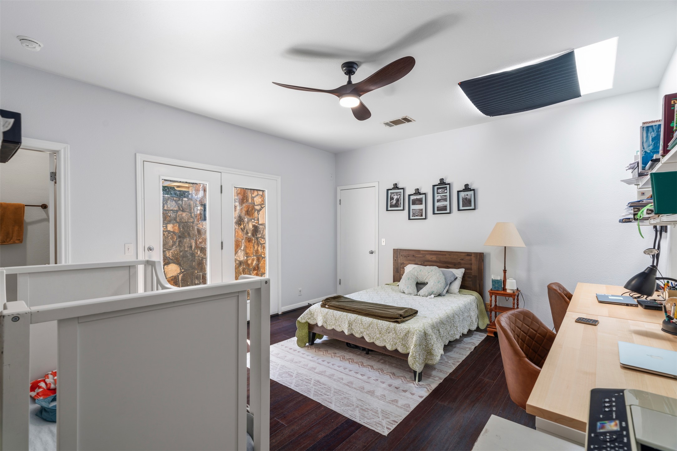 208 Amandas Way Leander, TX 78641 - Photo 18 of 25 Bedroom with a desk, dark wood-style flooring, access to exterior, and a ceiling fan
