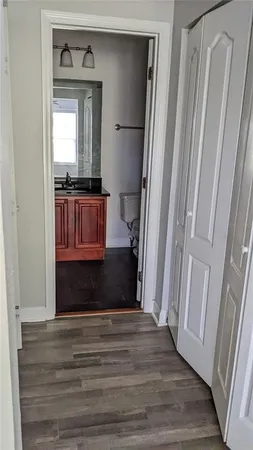 a bathroom with a sink a toilet a mirror and bathtub