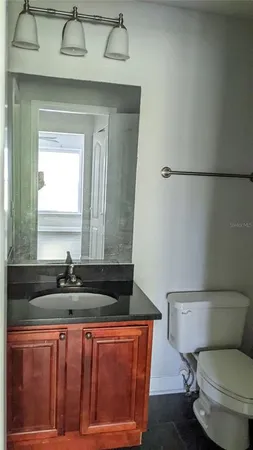 a kitchen with granite countertop wooden cabinets and a stove top oven