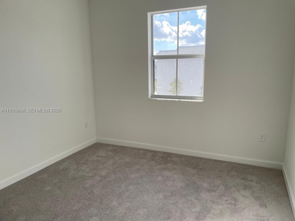 29081 Southwest 162th Court Homestead, FL 33033 - Photo 11 of 18 an empty room with a window