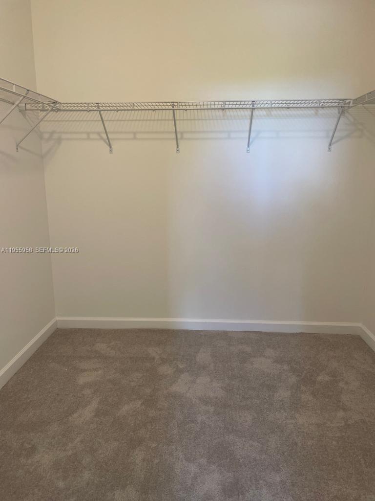 29081 Southwest 162th Court Homestead, FL 33033 - Photo 12 of 18 a view of a room with racks on the wall