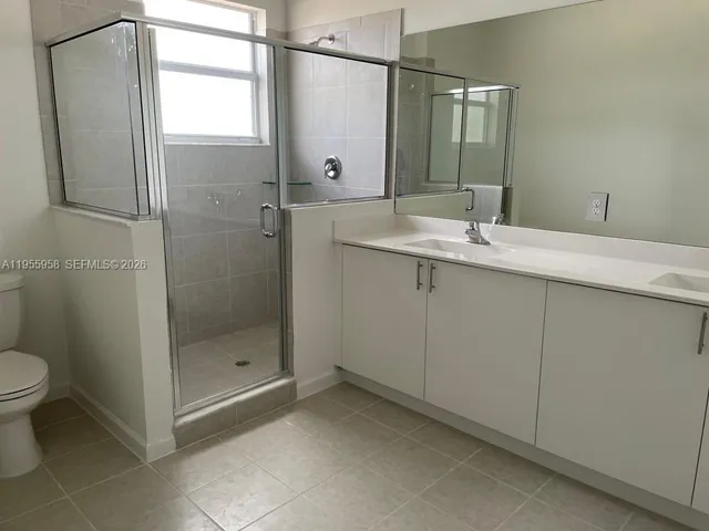 a bathroom with a shower sink and toilet