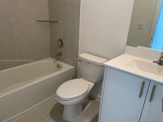 a white toilet sitting next to a bath tub