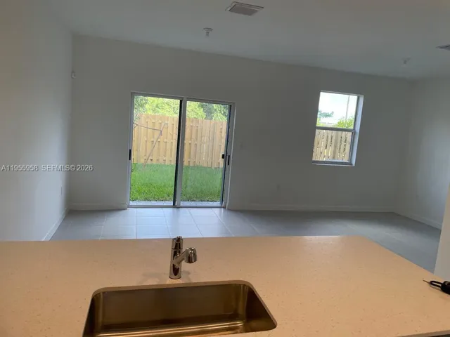 a room with window and a potted plant