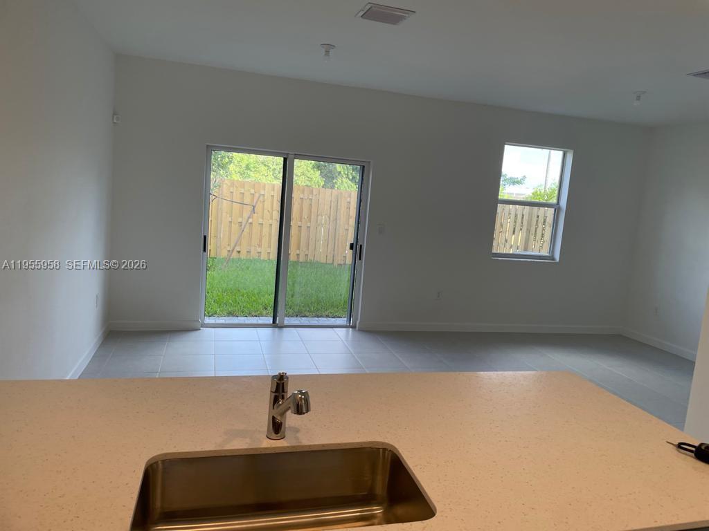 29081 Southwest 162th Court Homestead, FL 33033 - Photo 4 of 18 a room with window and a potted plant
