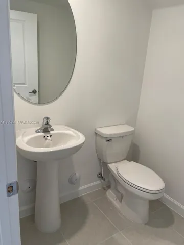 a white toilet sitting next to a bathroom sink