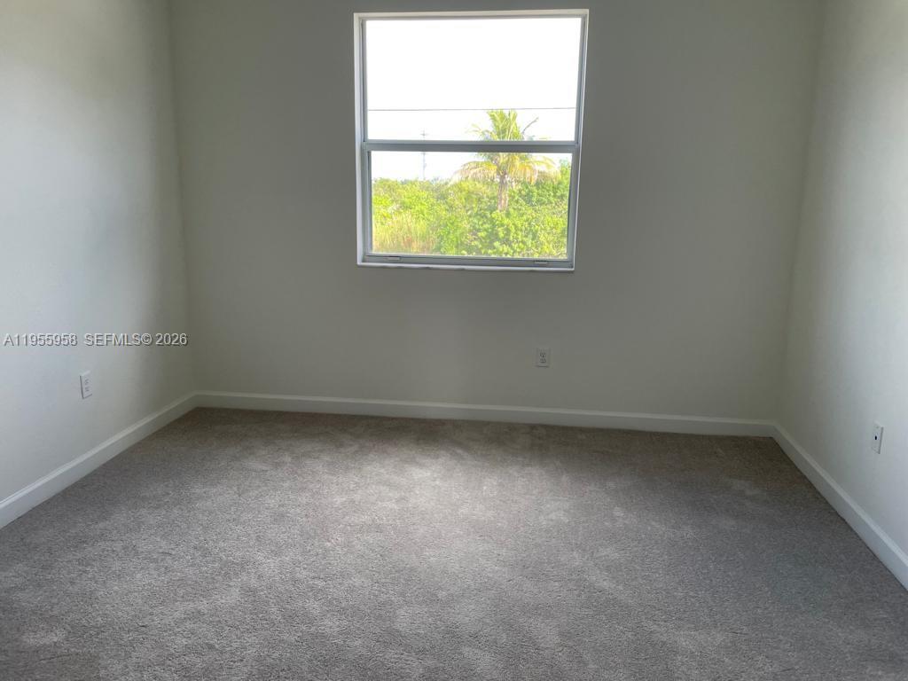 29081 Southwest 162th Court Homestead, FL 33033 - Photo 10 of 18 an empty room with a window