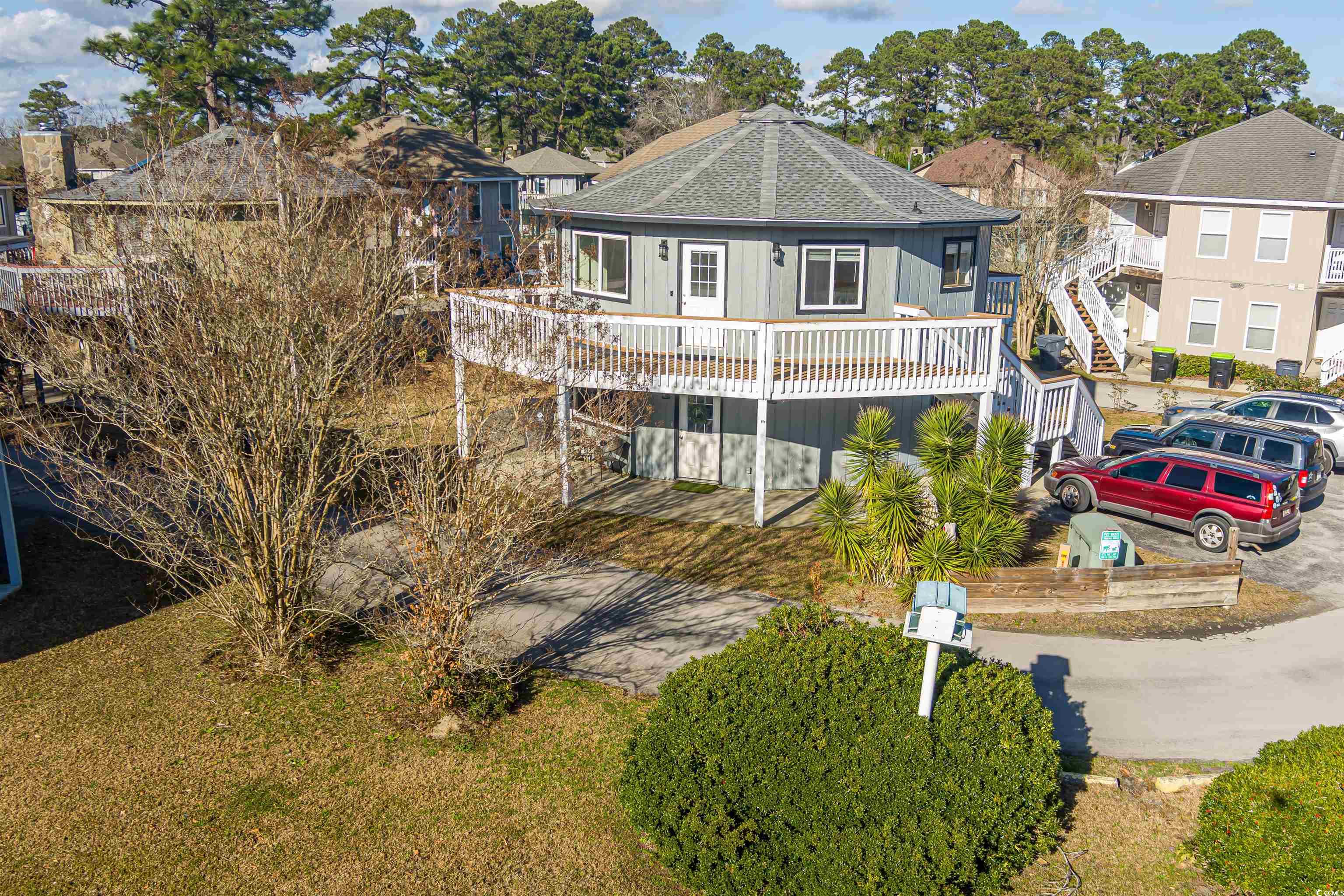 View of front of house featuring a shingled roof,