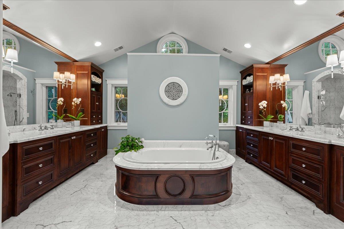 3510 Alpine Road Portola Valley, CA 94028 - Photo 27 of 77 a bathroom with a sink a large mirror and a bathtub