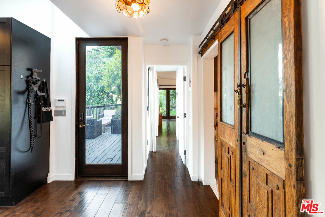 2016 Ewing Street Los Angeles, CA 90039 - Photo 13 of 33 a view of a hallway with wooden floor and glass door