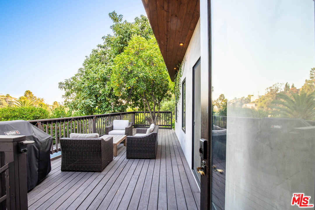 2016 Ewing Street Los Angeles, CA 90039 - Photo 21 of 33 a balcony with wooden floor and outdoor seating