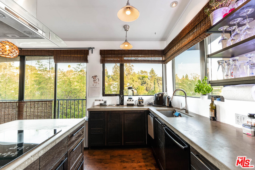 2016 Ewing Street Los Angeles, CA 90039 - Photo 10 of 33 a kitchen with stainless steel appliances a sink stove and cabinets