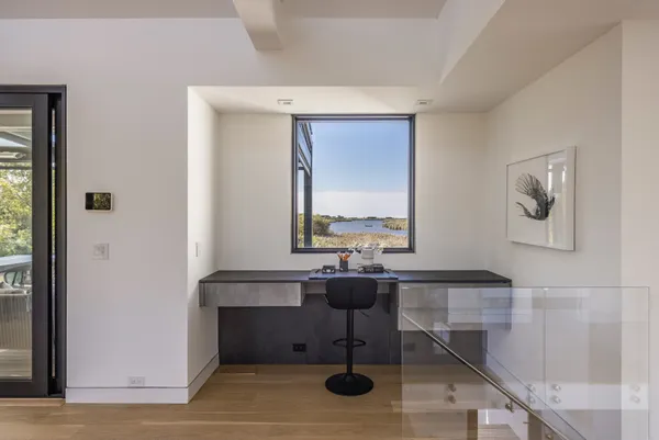 a view of a livingroom with workspace and a window