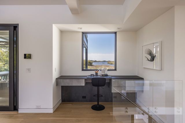 a view of a livingroom with workspace and a window
