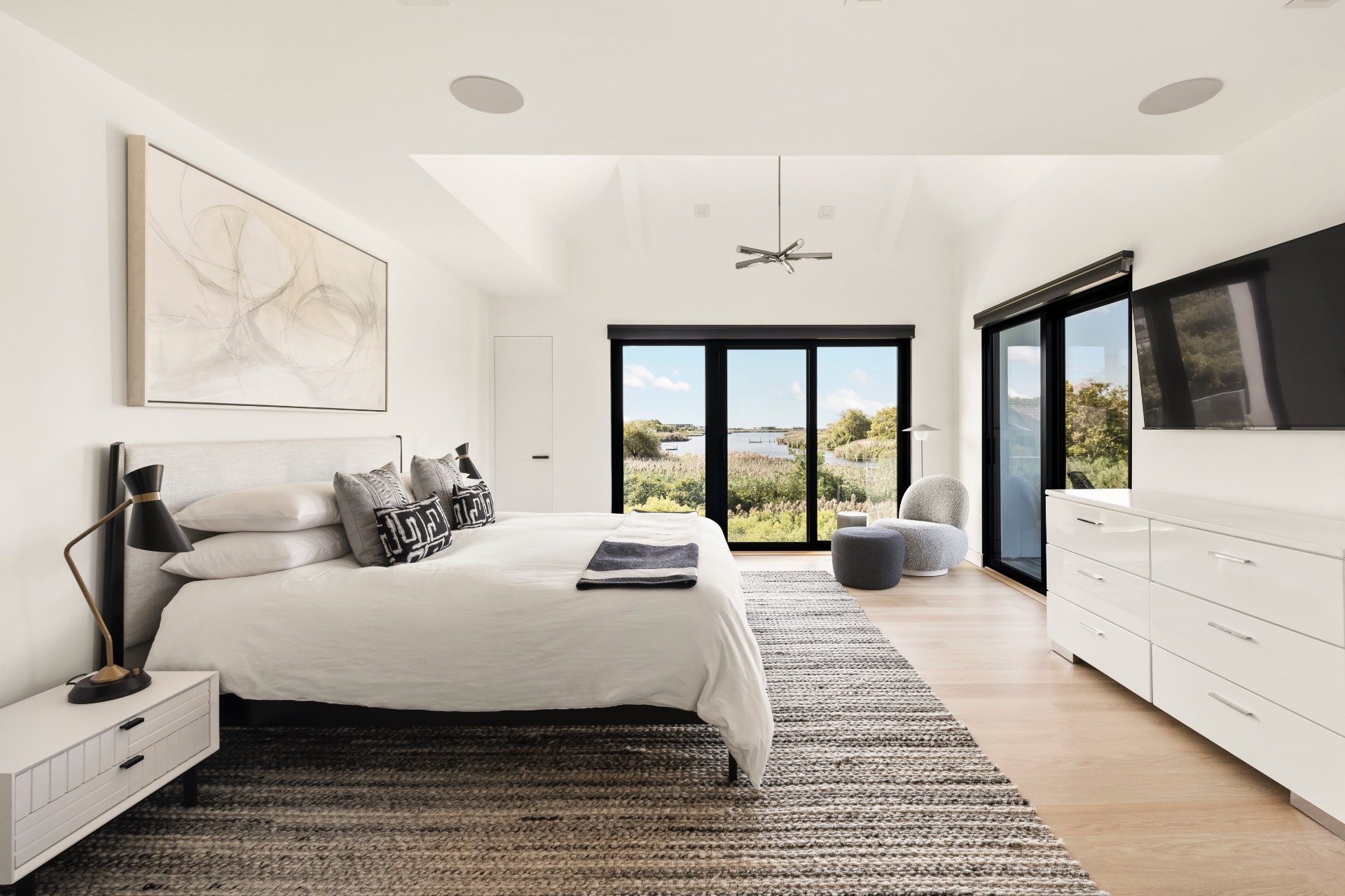 1076 Ocean Road Bridgehampton, NY 11932 - Photo 16 of 35 a bedroom with a large bed and a large window