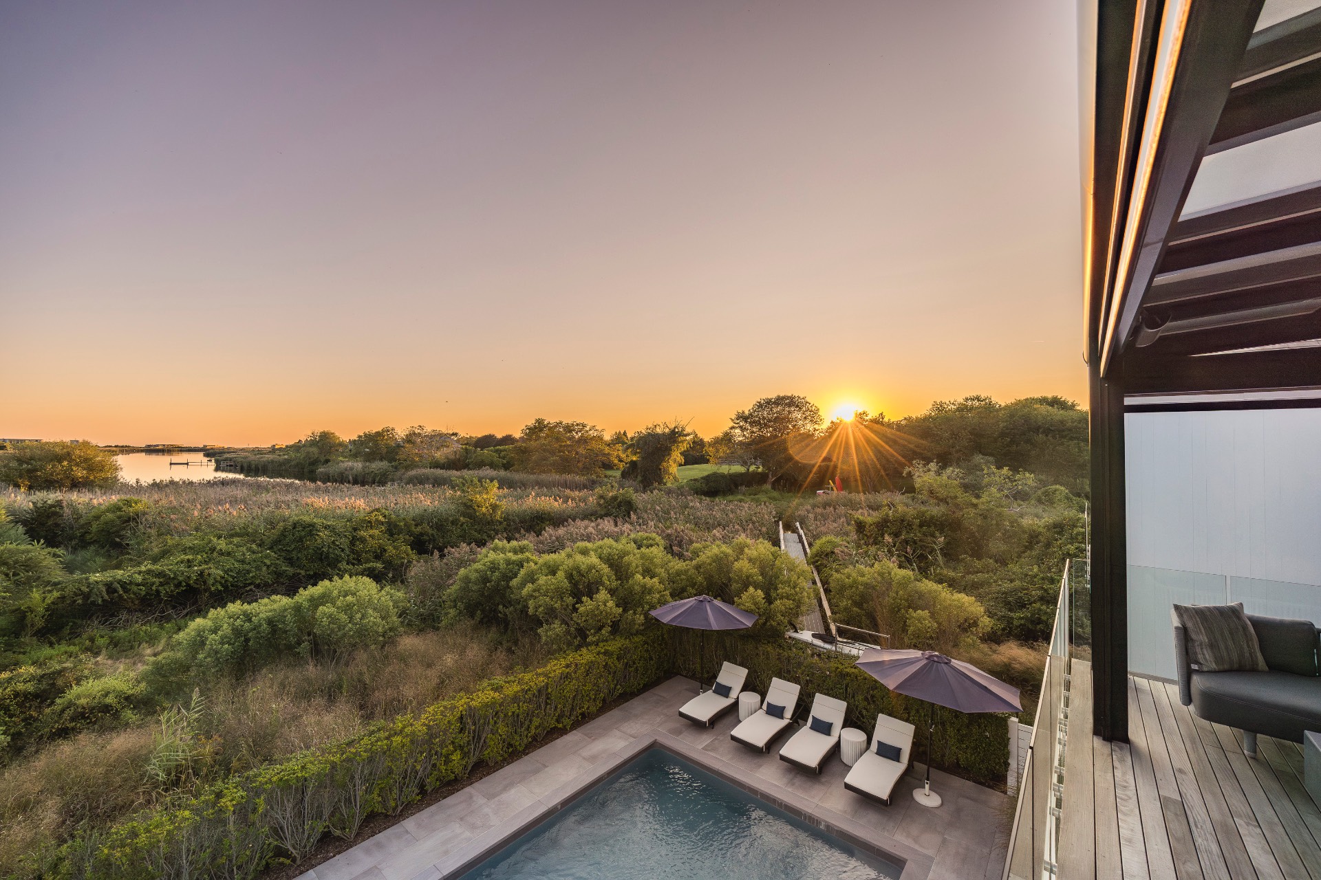 1076 Ocean Road Bridgehampton, NY 11932 - Photo 2 of 35 a view of a terrace with a yard