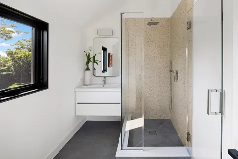 a bathroom with a sink a mirror and a shower