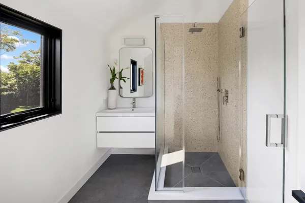 a bathroom with a sink a mirror and a shower