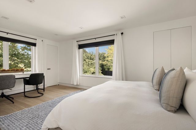 a bedroom with a bed and a chair